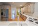 Well-lit kitchen with light wood cabinets, stainless steel refrigerator, and white countertops at 1336 Amberwood Dr, Woodstock, GA 30189