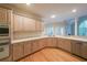 Spacious kitchen featuring stainless steel appliances, light wood cabinets, and hardwood floors at 1336 Amberwood Dr, Woodstock, GA 30189