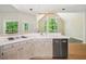 Kitchen view showcasing tiled countertops, cooktop, and view into the living room at 1336 Amberwood Dr, Woodstock, GA 30189