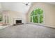 Inviting living room featuring a stone fireplace, large arched window, and natural light at 1336 Amberwood Dr, Woodstock, GA 30189