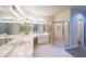 Spacious primary bathroom featuring white cabinets, sinks, mirrors, and a glass-enclosed shower at 1336 Amberwood Dr, Woodstock, GA 30189