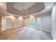 Spacious main bedroom with tray ceiling, carpet, and large windows overlooking greenery at 1336 Amberwood Dr, Woodstock, GA 30189