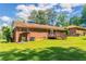 Brick home backyard with a wooden deck and a covered area showcasing the home's outdoor space at 2311 Cherry Blossom Sw Dr, Atlanta, GA 30331