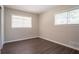 This bedroom offers two windows providing ample natural light and features modern flooring at 2311 Cherry Blossom Sw Dr, Atlanta, GA 30331
