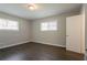 This bedroom offers two windows providing ample natural light and features modern flooring at 2311 Cherry Blossom Sw Dr, Atlanta, GA 30331
