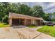 Brick ranch home with carport, mature trees, and a long driveway at 2311 Cherry Blossom Sw Dr, Atlanta, GA 30331