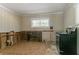 Kitchen featuring damage to the lower walls and an older appliance at 2311 Cherry Blossom Sw Dr, Atlanta, GA 30331
