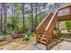 Backyard featuring a stone fire pit, seating, mature trees, stairway and landscaping at 3095 Willow Park Dr, Dacula, GA 30019