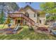 Backyard featuring a playset with swings and slide, firepit, mature trees, and a two-story home at 3095 Willow Park Dr, Dacula, GA 30019