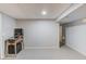 Finished basement with painted floors and a pinball machine at 3095 Willow Park Dr, Dacula, GA 30019
