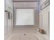 A relaxing tub with jets below a large window with decorative trim and artwork, creating a spa-like retreat at 3095 Willow Park Dr, Dacula, GA 30019