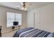 A calming bedroom featuring a striped bed, natural light, and a minimalist aesthetic at 3095 Willow Park Dr, Dacula, GA 30019