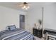 A simple bedroom featuring a striped bed, natural light, and neutral colors at 3095 Willow Park Dr, Dacula, GA 30019