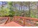 Wide angle shot from wooden deck overlooking the backyard, showing the railing and view of surrounding trees and landscape at 3095 Willow Park Dr, Dacula, GA 30019