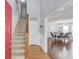 Inviting foyer featuring hardwood floors, a staircase, and an open view to the dining area at 3095 Willow Park Dr, Dacula, GA 30019