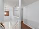 Bright hallway showcasing hardwood floors, fresh paint, and stylish lighting fixtures at 3095 Willow Park Dr, Dacula, GA 30019