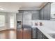 Bright kitchen with stainless steel fridge, grey cabinets, and adjacent breakfast nook at 3095 Willow Park Dr, Dacula, GA 30019