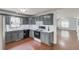 Inviting kitchen with updated appliances, grey cabinets, and an adjacent living area at 3095 Willow Park Dr, Dacula, GA 30019