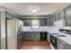 Charming kitchen featuring grey cabinets, stainless steel appliances, and ample counter space at 3095 Willow Park Dr, Dacula, GA 30019