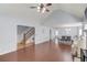 Open-concept living area with hardwood floors, fireplace, and seamless flow into the dining room at 3095 Willow Park Dr, Dacula, GA 30019