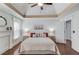 Comfortable bedroom with a trey ceiling, decorative fireplace, and natural light at 3095 Willow Park Dr, Dacula, GA 30019