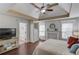 Serene bedroom with a trey ceiling, decorative fireplace, and ensuite bathroom at 3095 Willow Park Dr, Dacula, GA 30019
