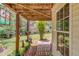 Exterior view of a ground level stone patio, showcasing the natural landscaping, decorative plants, and view of the home at 3095 Willow Park Dr, Dacula, GA 30019