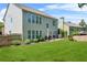 View of a spacious backyard with a manicured lawn and a charming patio seating area at 450 Hammersmith Dr, Suwanee, GA 30024