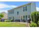 Exterior view of the home showcasing a large backyard with a patio seating area at 450 Hammersmith Dr, Suwanee, GA 30024