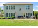 Exterior view of the home showcasing a large backyard with a patio seating area at 450 Hammersmith Dr, Suwanee, GA 30024
