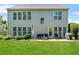 Exterior view of the home showcasing a large backyard with a patio seating area at 450 Hammersmith Dr, Suwanee, GA 30024