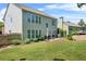 View of a spacious backyard with a manicured lawn and a charming patio seating area at 450 Hammersmith Dr, Suwanee, GA 30024