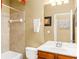 Bathroom featuring tiled shower, vanity with sink, and framed mirror at 450 Hammersmith Dr, Suwanee, GA 30024