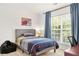 Neutral bedroom with a large window and blue accents at 450 Hammersmith Dr, Suwanee, GA 30024