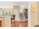 Inviting entryway featuring hardwood floors, staircase, and open access to the kitchen and dining area at 450 Hammersmith Dr, Suwanee, GA 30024