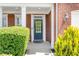 Inviting front porch with classic brickwork and well-maintained landscaping details at 450 Hammersmith Dr, Suwanee, GA 30024