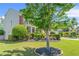 Landscaped front yard featuring lush greenery and a mature tree enhancing the home's setting at 450 Hammersmith Dr, Suwanee, GA 30024
