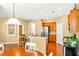 Open-concept kitchen with breakfast bar, stainless steel appliances, and hardwood floors at 450 Hammersmith Dr, Suwanee, GA 30024