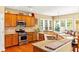 Well-equipped kitchen with stainless steel appliances, granite countertops, and a breakfast bar at 450 Hammersmith Dr, Suwanee, GA 30024