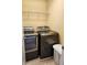 Convenient laundry room features modern washer and dryer with overhead storage rack for added organization at 450 Hammersmith Dr, Suwanee, GA 30024