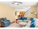 Spacious living room featuring comfortable seating, hardwood floors, and staircase access at 450 Hammersmith Dr, Suwanee, GA 30024
