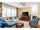 Comfortable living room with a fireplace, plush seating, and plenty of natural light at 450 Hammersmith Dr, Suwanee, GA 30024