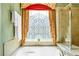 Close up of the main bathroom soaking tub with a decorative window at 450 Hammersmith Dr, Suwanee, GA 30024