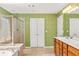 Main bathroom featuring double sinks, a soaking tub, and a separate shower at 450 Hammersmith Dr, Suwanee, GA 30024