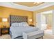 Comfortable main bedroom with a tray ceiling, upholstered headboard, and an ensuite at 450 Hammersmith Dr, Suwanee, GA 30024