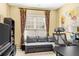 Cozy home office with a comfortable sofa, desk, and built-in bookshelves at 450 Hammersmith Dr, Suwanee, GA 30024