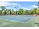 Outdoor tennis courts surrounded by trees and greenery at 450 Hammersmith Dr, Suwanee, GA 30024