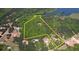 Aerial view of expansive property outlined in yellow, displaying acreage, trees, and structures at 60 Browning Shoals Rd, Social Circle, GA 30025