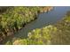 An aerial shot shows the waterway with lush tree-lined banks, providing a serene and natural landscape at 60 Browning Shoals Rd, Social Circle, GA 30025