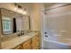 Bathroom with a granite countertop vanity, sleek fixtures, and a bathtub-shower combo at 60 Browning Shoals Rd, Social Circle, GA 30025